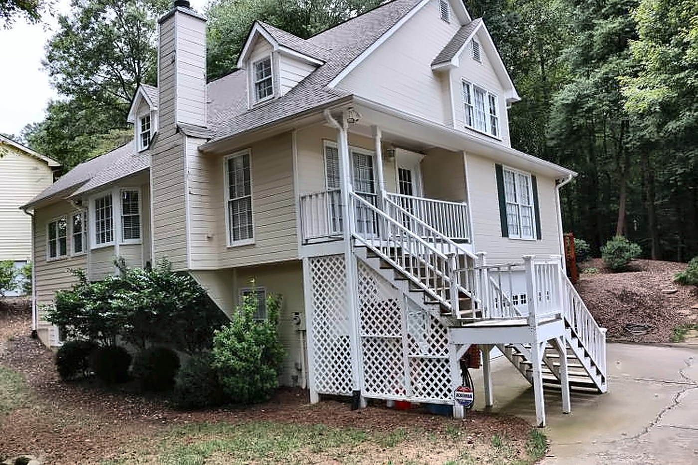 Before: cream house with white porch stairs